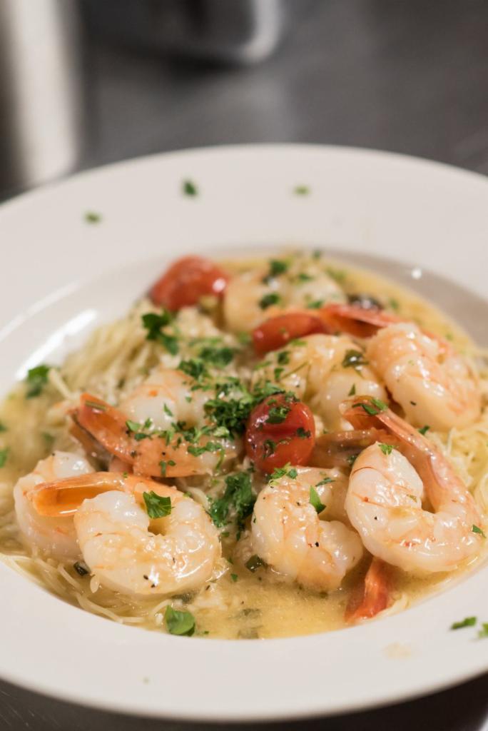 Shrimp Scampi · Eight large shrimp sauteed with cherry tomatoes in a garlic, white wine butter sauce, served over angel hair.