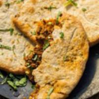 Keema Naan · Leavened bread stuffed with mildly spiced ground lamb.
