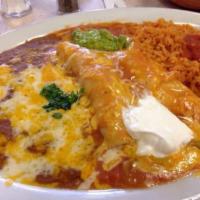 Enchiladas de Carnitas · Two enchiladas stuffed with our homemade carnitas topped with salsa ranchera, cheese, pico d...