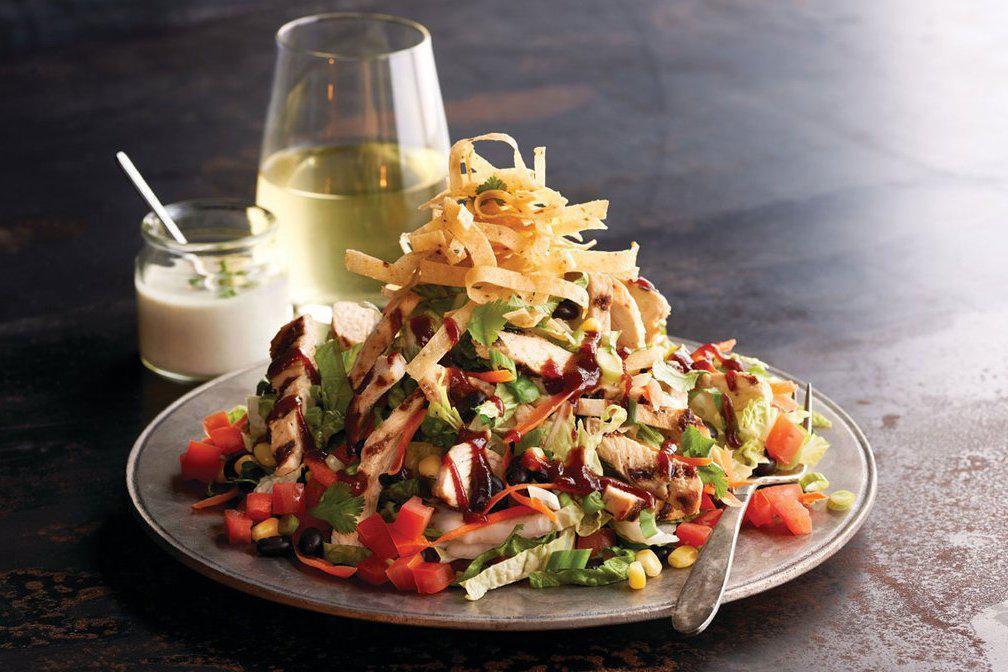 BBQ Chicken Salad · Grilled chicken with corn, black beans, carrots, tomato, green onions, cilantro and crisp corn tortilla strips. Tossed with house-made ranch dressing and sweet BBQ sauce