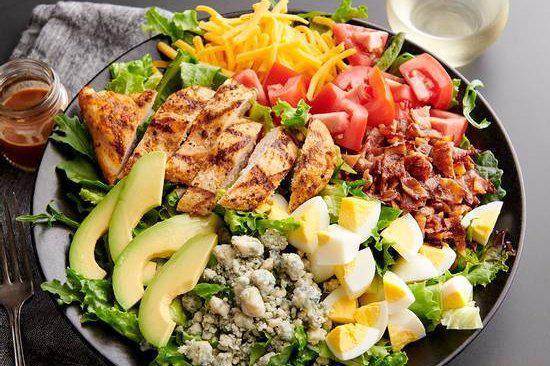 Chopped Cobb Salad · Grilled chicken, crispy bacon, avocado, diced egg and tomatoes with bleu cheese crumbles and house-made bleu cheese dressing 