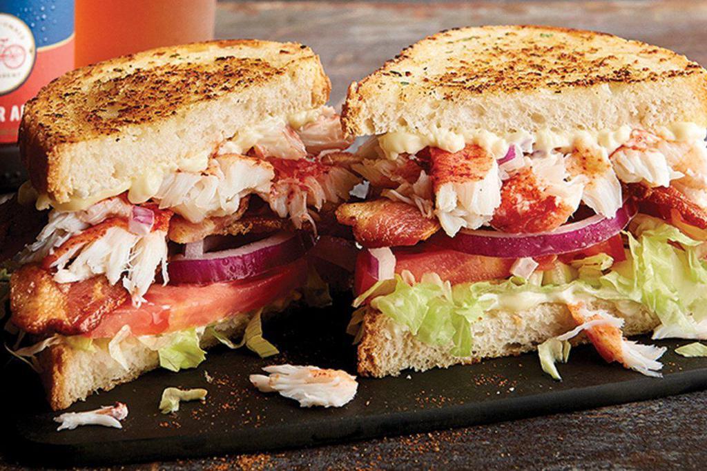 Lobster BLT · Lobster claw meat, Applewood-smoked bacon, sliced tomatoes, shredded lettuce, red onion, and Parmesan-crusted sourdough bread.