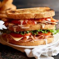 Clubhouse Sandwich · Sliced turkey, ham and smoked bacon topped with provolone and cheddar cheese, fresh greens, ...