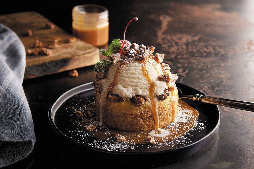Caramel Pecan Butter Cake · Candied pecans, caramel sauce, cream cheese butter cake and vanilla ice cream