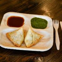 Samosa (2 pcs) · Fried pastry with a savory potato filling served with mint and tamarind chutneys. Vegan.