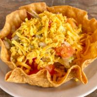 Taco Salad · Crispy flour tortilla bowl, choice of taco meat or shredded chicken, lettuce, tomato, and Am...