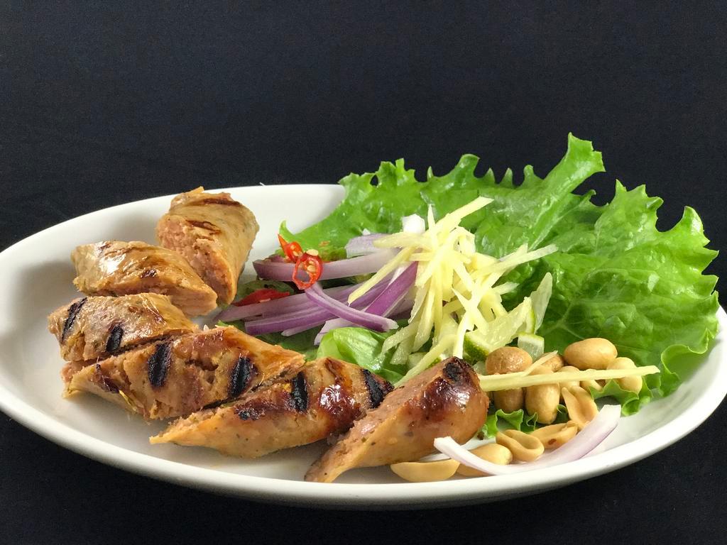 Thai Herb Sausage · Roasted Thai Northern style herb sausage, with peanut, cut ginger, sliced red onion, lemon and chili.