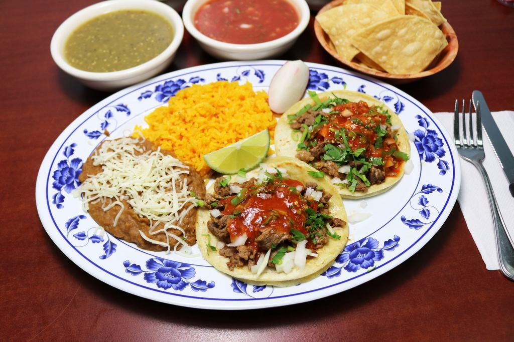 39. Soft Double Taco Combo · 2 tacos filled with your meat choice, onion, cilantro, salsa a side of rice and refried beans.
