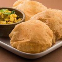 Poori Bhaji · Baby potatoes pan stir field and tempered with curry leaves and mild spices served with poor...