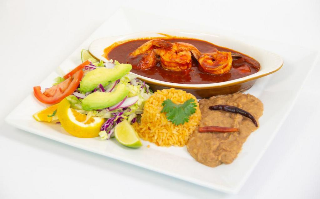 Camarones a la Diabla · Shrimp with red hot sauce, homemade chorizo and beans mix and rice.