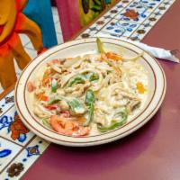 Pollo con Crema · Tender chicken strips cooked in an authentic sour cream sauce with green peppers, onions, an...