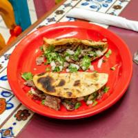 Tacos de la Montana · Three tacos charbroiled tortilla topped with beans, fresh cheese, homemade salsa, cilantro, ...