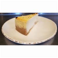 CREAMY NY STYLE CHEESECAKE · Creamy New York style cheesecake atop a graham cracker crust.