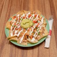 Super Nachos · House-made tortilla chips, topped with melted Jack cheese, choice of beans, crema, guacamole...