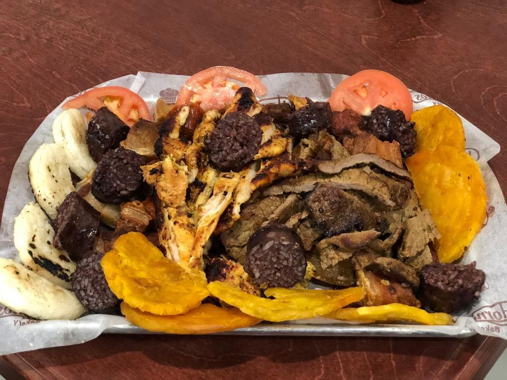 Picada Colombiana Plate · Grilled steak, grilled chicken, Colombian sausage, pork skin, blood sausage, green plantain and corn cake for 4 people.
