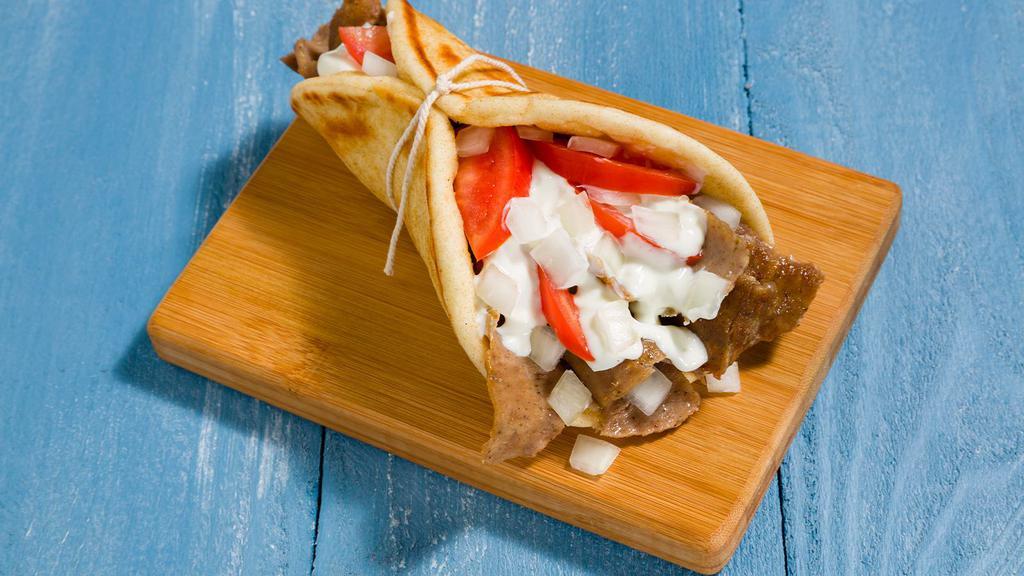 Yeero (Gyro) · Greek Souvlaki's favorite. Gyro. The hamburger of Greece!!! A mixture of Iamb and beef cooked on a vertical rotisserie, sliced and put into pita bread with onions, tomatoes, choice of sauce.