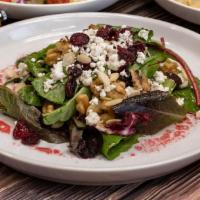 Mesclun Goat Cheese Salad · Tender mesclun salad with crumbled goat cheese, tangy cranberries, walnuts and a raspberry v...