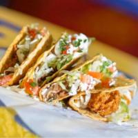 Shredded Chicken Taco · Shredded chicken served on a soft corn tortilla and topped with garlic sauce, lettuce, tomat...