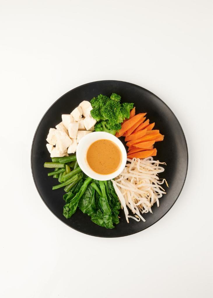 Showering Rama · Steamed Chinese broccoli, bean sprouts, string bean, carrot, broccoli, and tofu served with peanut sauce and rice on the side. Gluten-free, vegan.

