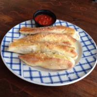 Garlic Bread · Our famous fresh baked buttery breadsticks topped with garlic and parmesan and served with a...