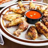 12 Piece Chicken Wings · Herb roasted chicken wings baked in our 600 degree oven with your choice of honey Sriracha h...