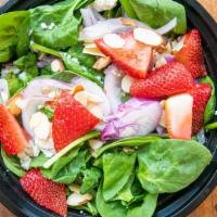 Spinach Salad · Spinach with seasonal fruit (strawberries in the summers) toasted almonds, red onions, tomat...
