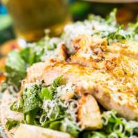 Caesar Salad · Romaine hearts tossed with Parmigiano-Reggiano, croutons, and Caesar dressing. Pictured has ...