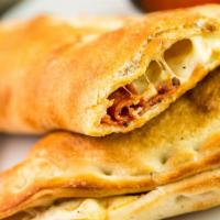 Combo Calzone · Pepperoni, sausage, mushroom, green pepper and Mozzarella. Served with a side of Pasquini fa...