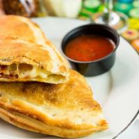 Create Your Own Calzone · Pasquini family recipe pizza sauce, Mozzarella and your choice of pizza toppings. Served wit...