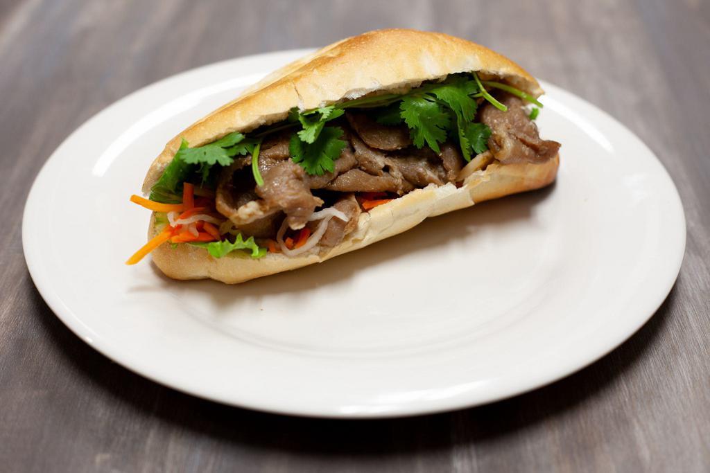 Grilled Pork Banh Mi · French bread, cilantro, green leaf, pickled daikon and carrot.