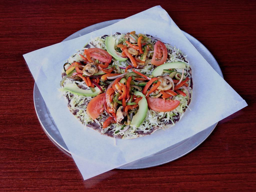 Tlayuda Vegetarian · Extra large toasted tortilla, a spread bean puree, lettuce, tomato, onion, avocado, cheese and sauteed bell peppers, onions and mushrooms.
