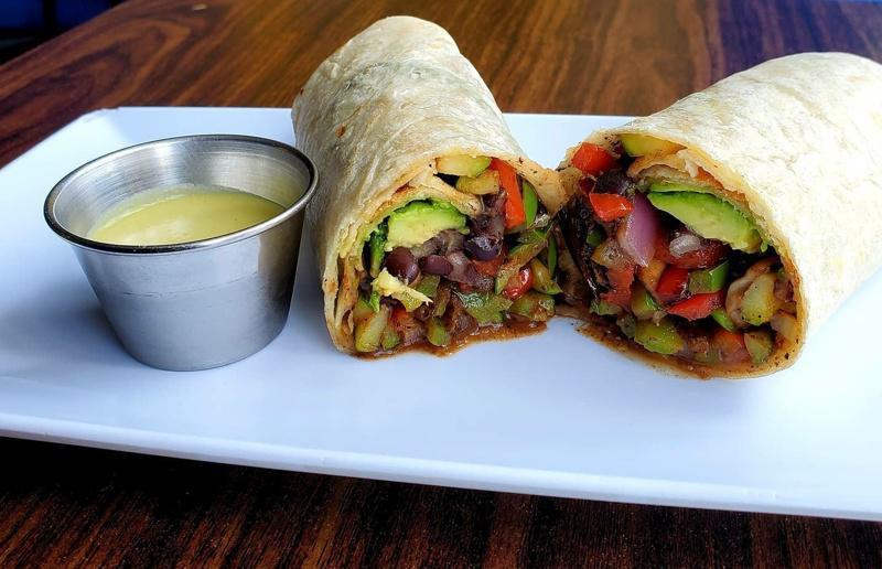 Vegetarian Burrito · Grilled mushrooms, bell peppers, zucchini and onion. Served with black beans, cheese, lettuce, tomato, onion and avocado