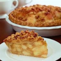 Apple Caramel Walnut Pie · Fresh Ida red diced apples in rich caramel sauce fill a flaky, double crusted pie that’s han...