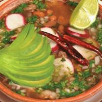 Carne en su Jugo · Bean soup with chopped steak and bacon accompanied with radishes, onion, cilantro, and avoca...