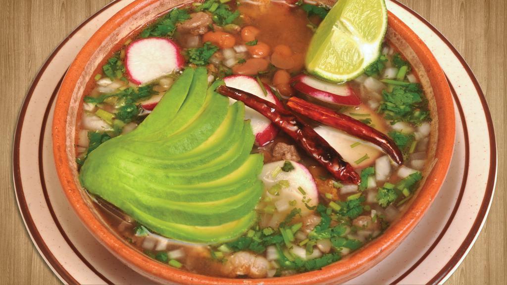 Carne en su Jugo · Bean soup with chopped steak and bacon accompanied with radishes, onion, cilantro, and avocado.