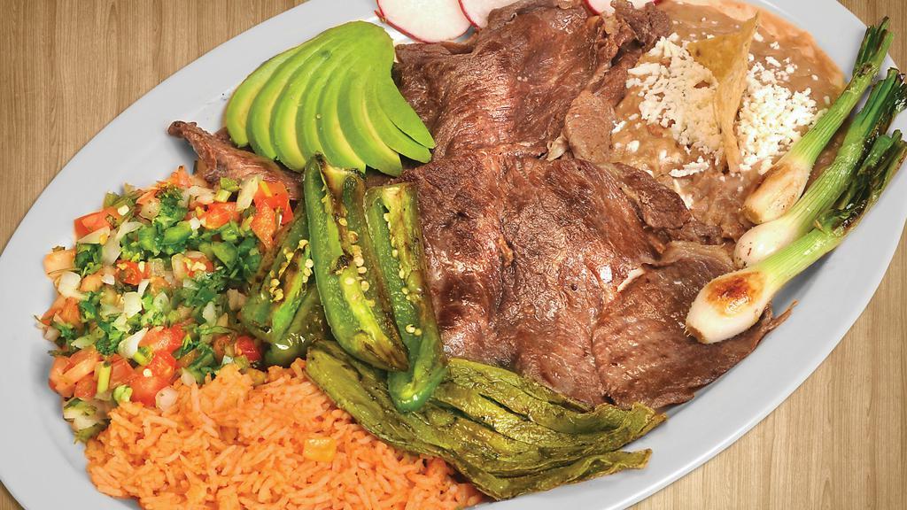 Cecina el Mezquite Platillo · Cured steak. Served with beans, rice, pico de gallo, avocado, radishes, grilled green onions, and nopal.