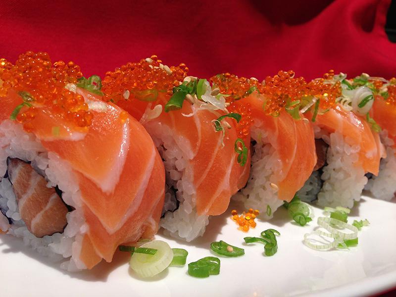 J.J. Salmon Roll · Spicy salmon and avocado wrap topped with sliced salmon and salmon caviar.