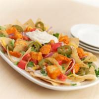 Buffalo Chicken Nachos · Tortilla chips layered with chicken tossed in our Buffalo hot sauce, lettuce, tomatoes, red ...