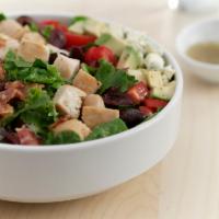 Classic Cobb Salad · A blend of greens topped with diced grilled chicken, avocado, hard-cooked eggs, applewood-sm...