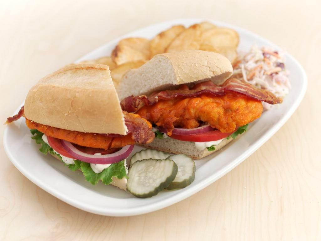 Buffalo Chicken Club · Grilled or fried tenders tossed in our Buffalo hot sauce, topped with applewood-smoked bacon, lettuce, tomato and your choice of bleu cheese dip or ranch dressing; served on a brioche bun.