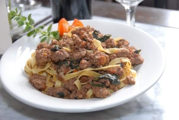 Fettuccine Bolognese · Homemade fettuccine tossed in a traditional tomato and meat sauce.