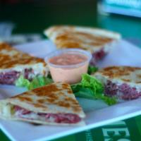 Reuben Quesadilla · Shaved corned beef, Swiss cheese, sauerkraut, melted together on a grilled flour tortilla an...
