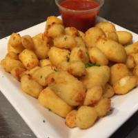 Cheese Curds · White cheddar curds battered and fried served with marinara or ranch.