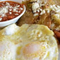 Chilaquiles · Homemade corn tortilla chips sauteed with green tomatillo salsa topped with cheese, served w...