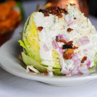 Wedge Salad · Iceberg, bacon, red onion, bleu cheese crumbles.