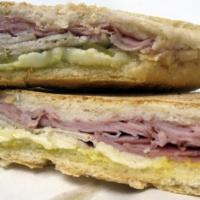 Cubano Sandwich · Cuban sandwich with pork, ham, Swiss cheese, pickles and mustard, toasted and glazed with ga...