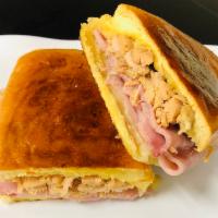 Media Noche Sandwich · Midnight sandwich. Sweet bread with pork, ham, Swiss cheese, pickles and mustard, toasted an...