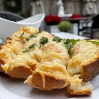 Cheesy Garlic Bread · Buttery bread that is topped with garlic.