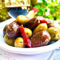 House Marinated Olives · Soaked in a sauce. 