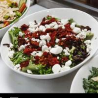 Crumbled Goat Cheese Salad · Organic mixed greens, baby arugula, crumbled goat cheese, sun-dried tomatoes, roasted red pe...